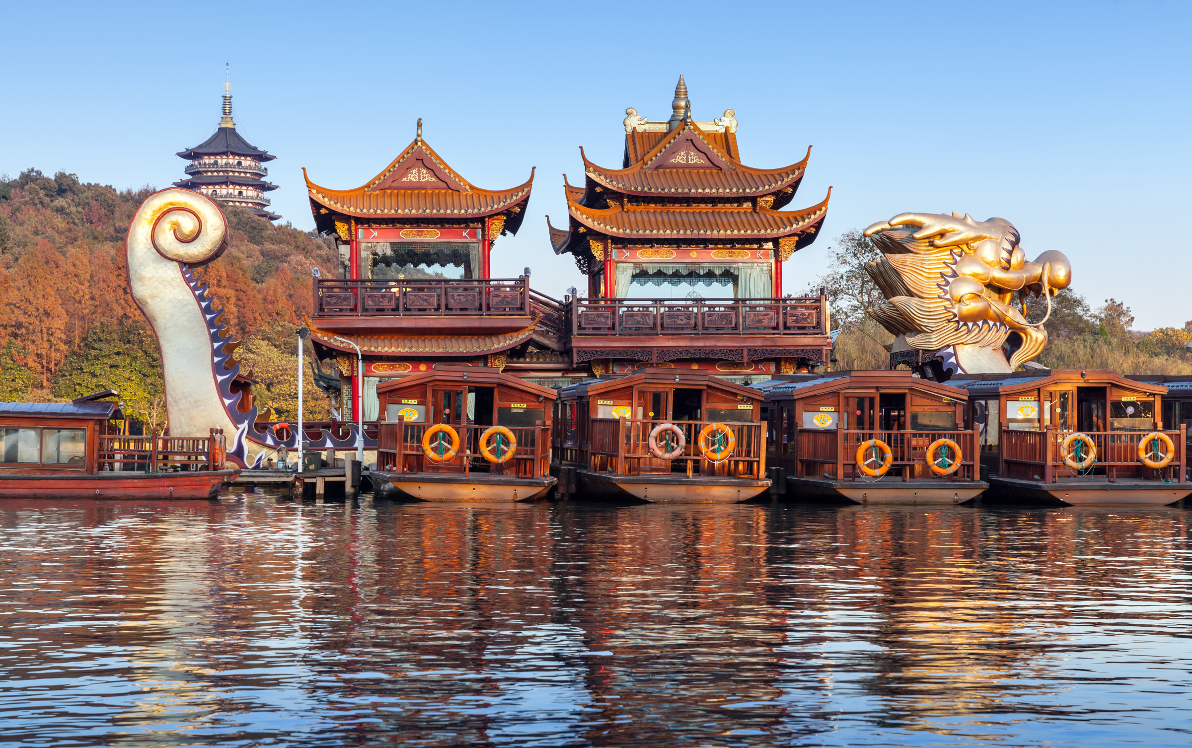 Hangzhou China - December 5 2014: Traditional Chinese wooden recreation boats and Dragon ship are moored on the West Lake. Famous park in Hangzhou city center China